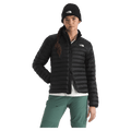 View of a woman wearing The North Face Terra Peak Jacket for Women in Black featuring a full front two-way zip with internal draft flap, zip side pockets, and a heat transfer white logo on the left chest