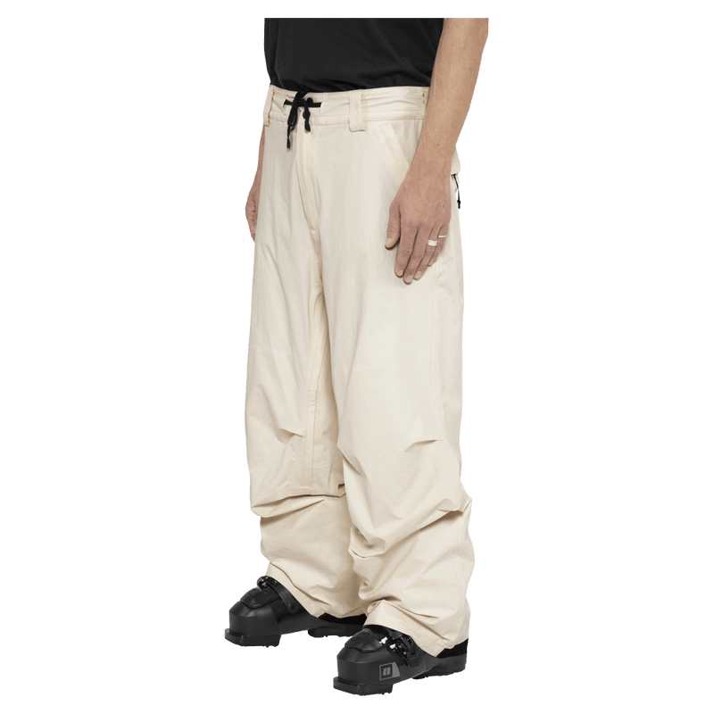 Side view of the Armada Chairman 2L Pants in Cream colourway, unisex's model