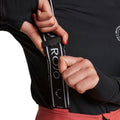 Close-up of adjustable black and white Rojo branded suspenders on pink softshell high rise ski pants.