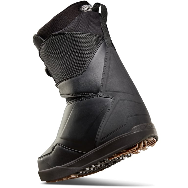 Side profile of a black Thirtytwo Lashed Double BOA snowboard boot with mesh panels and a textured brown rubber sole.