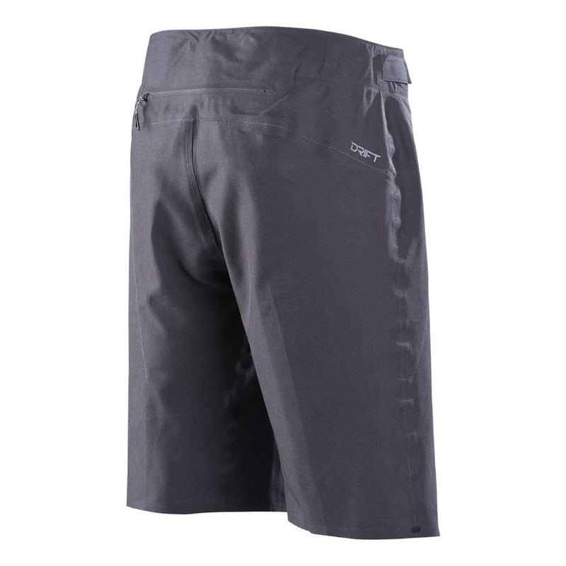 Troy Lee Designs Drift MTB shorts in charcoal grey with a rear zipper pocket and side logo, back three-quarter view.